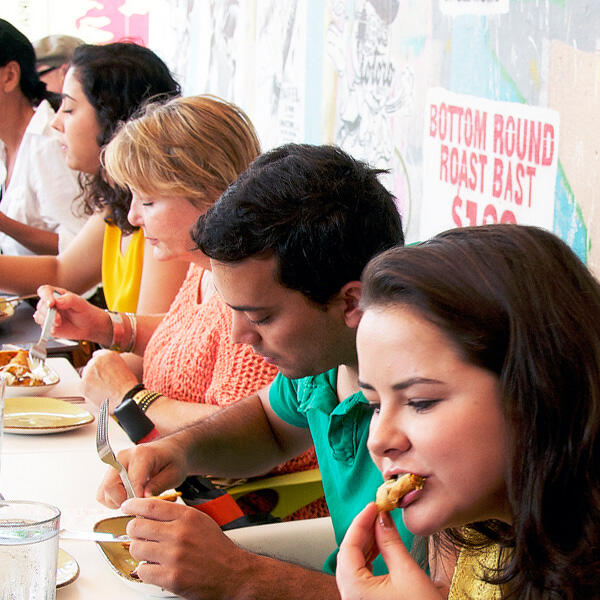A culinary group enjoying a meal at a table during one of Miami Food Tours.
