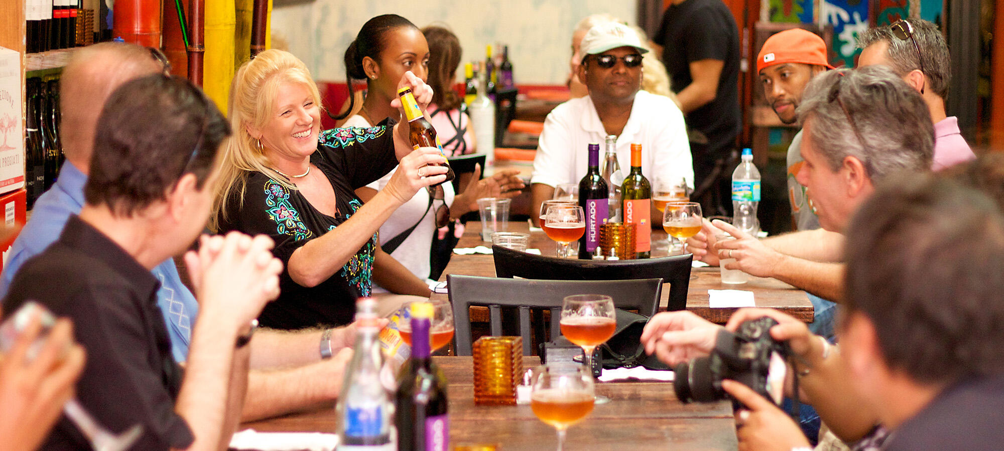 A culinary group enjoying wine at a table during a Miami Food Tour in Little Havana.
