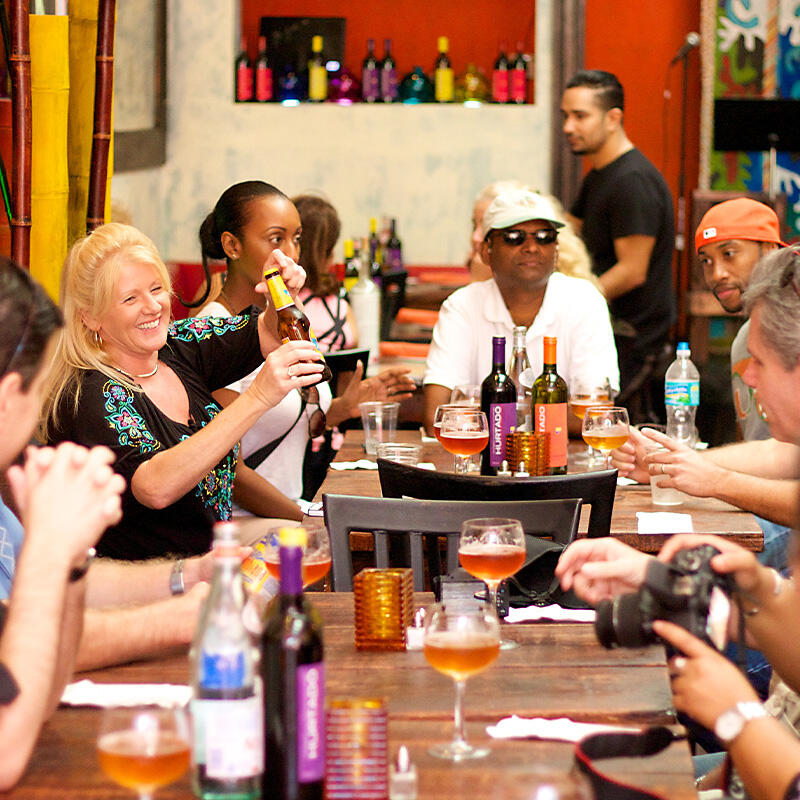 A group of people enjoying a culinary tour at a table.