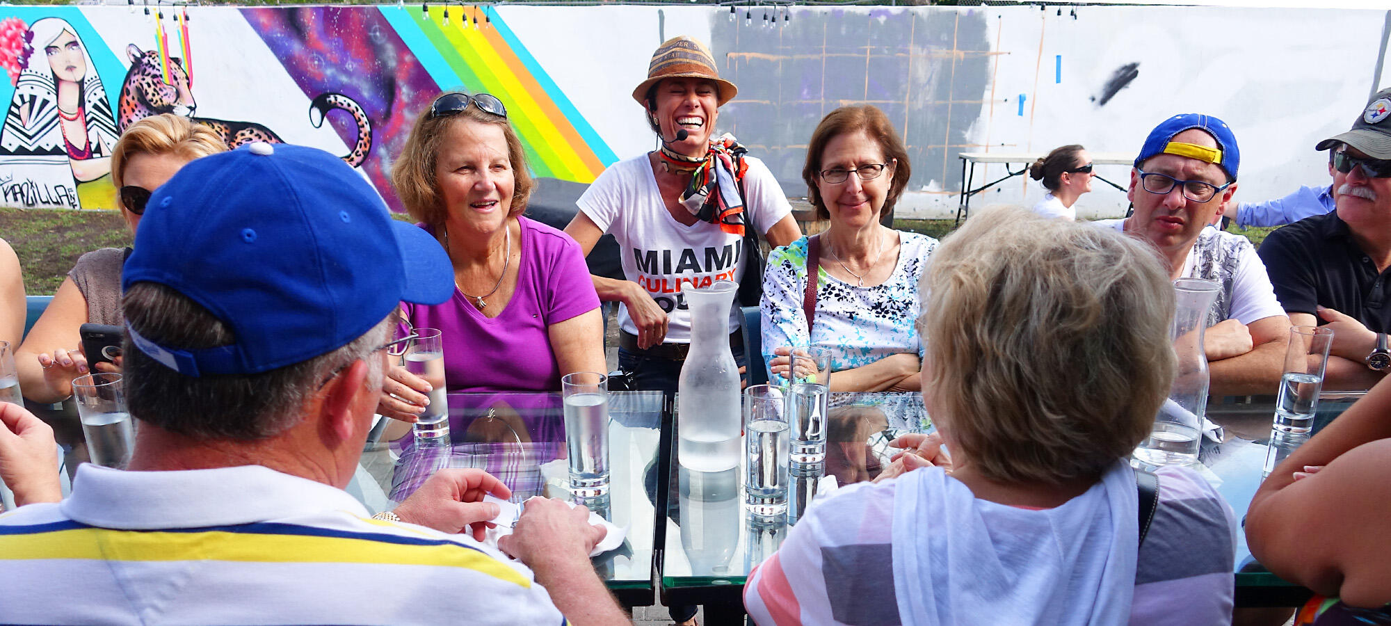 A group of people enjoying a private culinary tour while sitting around a table.