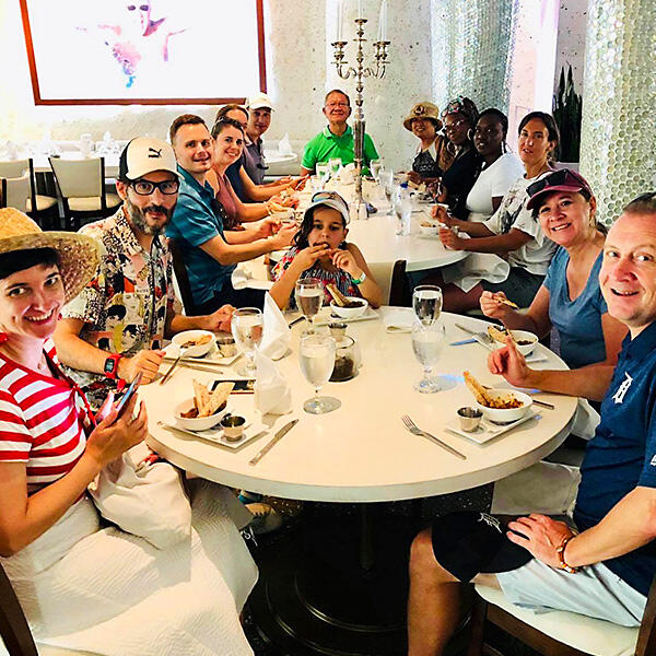 A group of people participating in Private Tours sitting at a table.