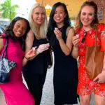 A group of women on a Private Tour posing for a picture in front of a store.