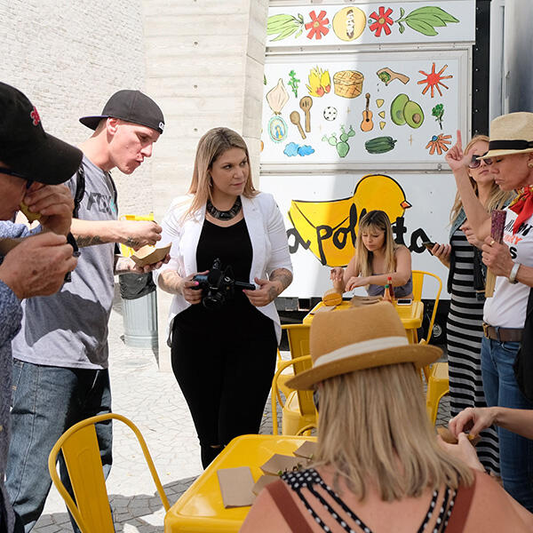 A group of people on a Miami Food Tour, standing in front of a food truck.
