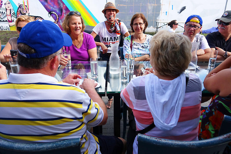 A group of people enjoying a Private Tour at a table.