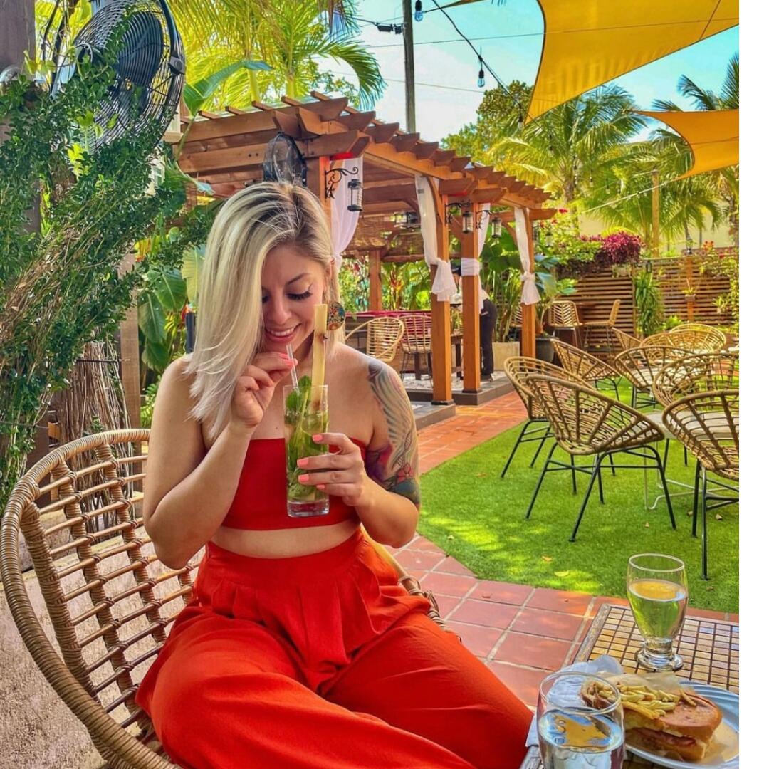 A woman enjoying a drink on a private patio.