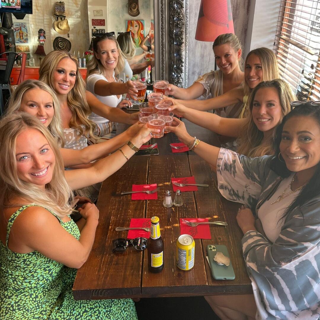 A group of women toasting at a restaurant.