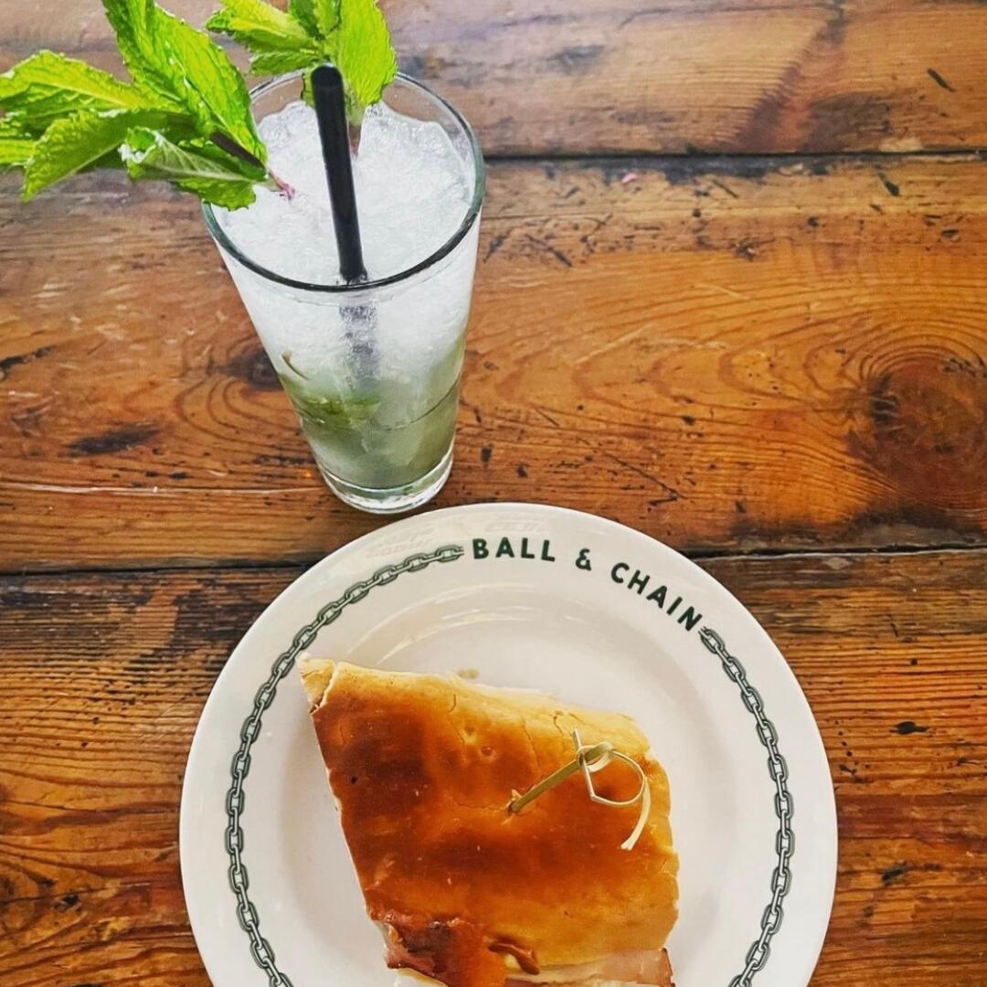 A plate with a piece of pie and a drink on it, showcased during one of our Miami Food Tours.