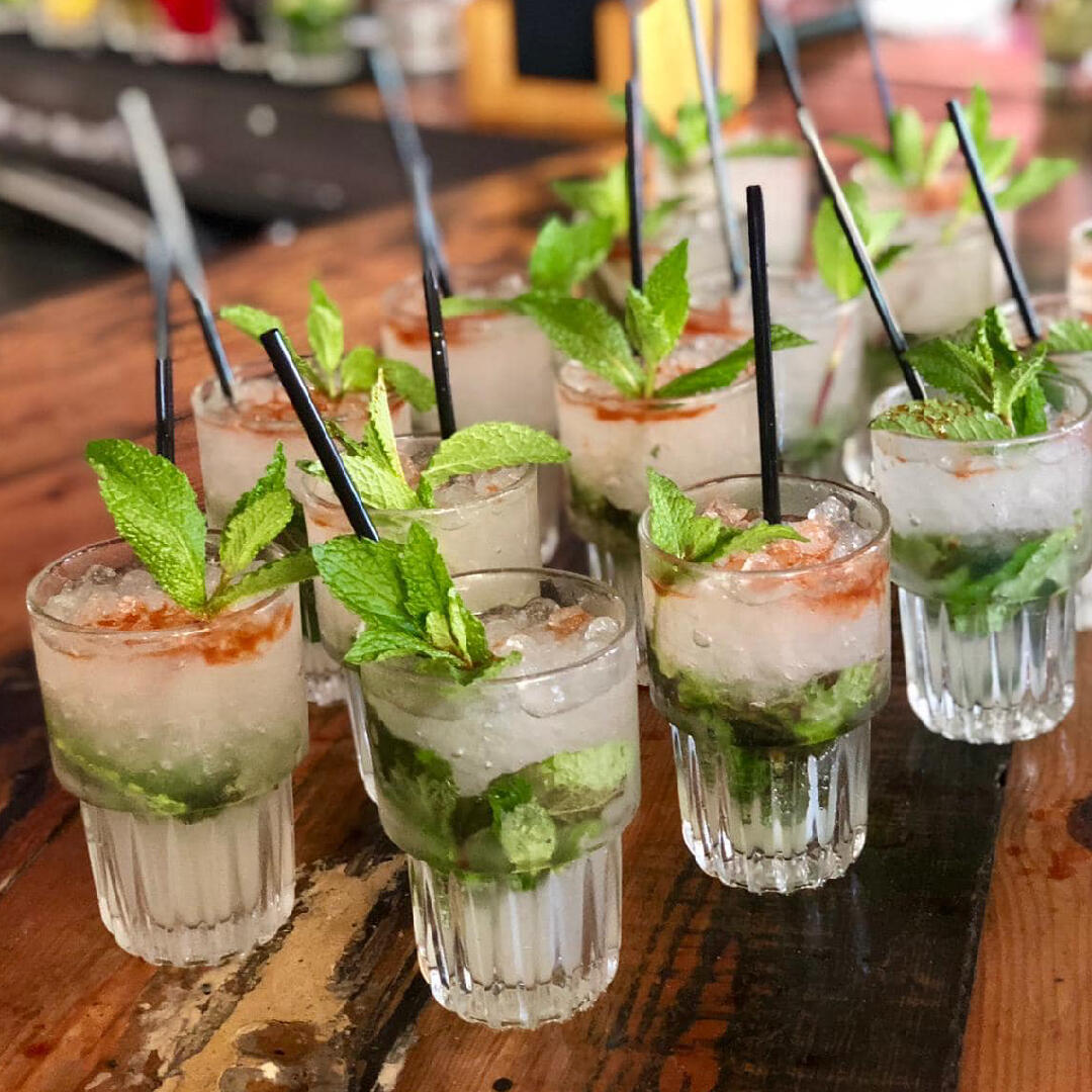 Mojitos on a wooden table at a culinary tour.