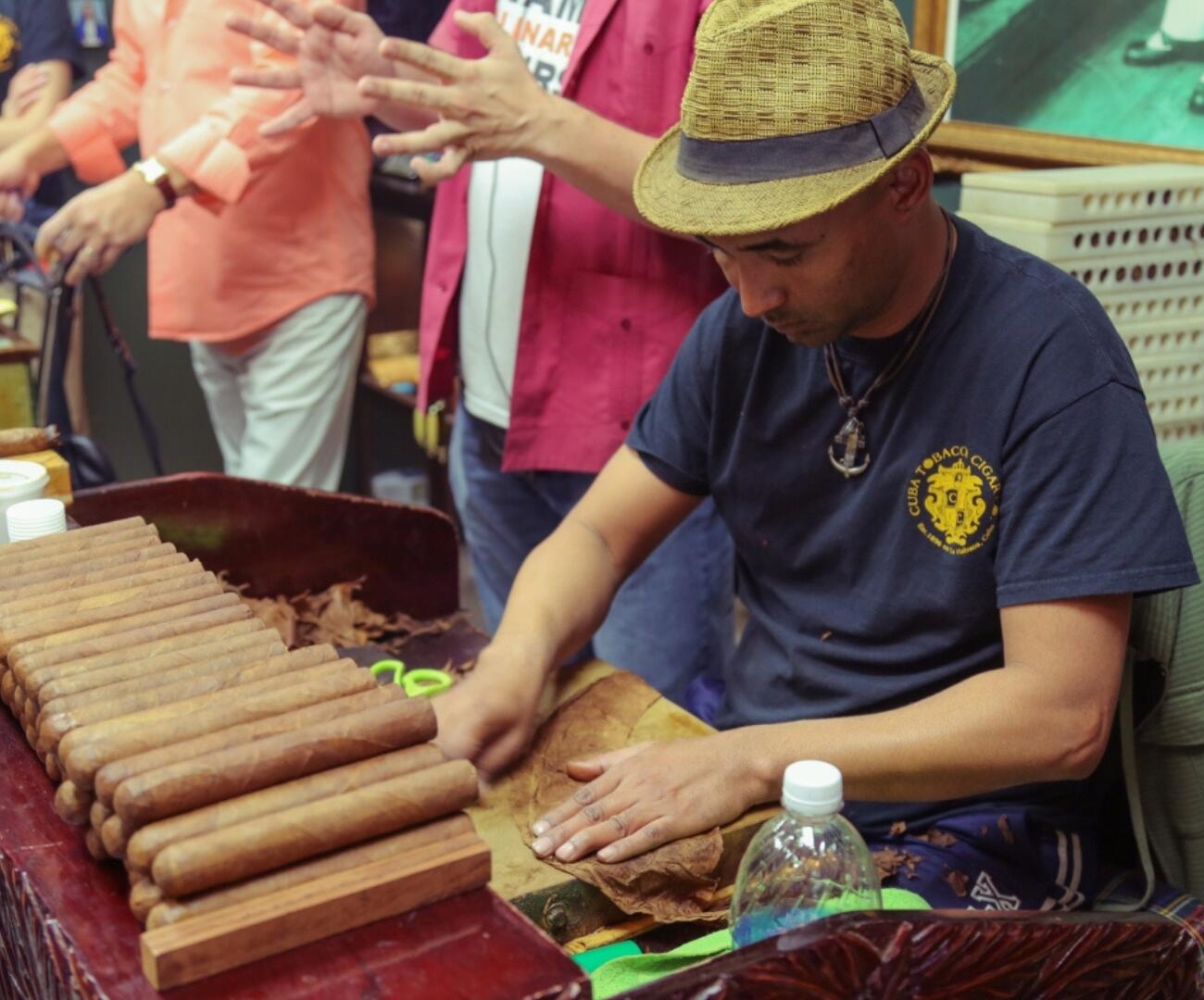         Description: A man in a hat is playing a private cigar.