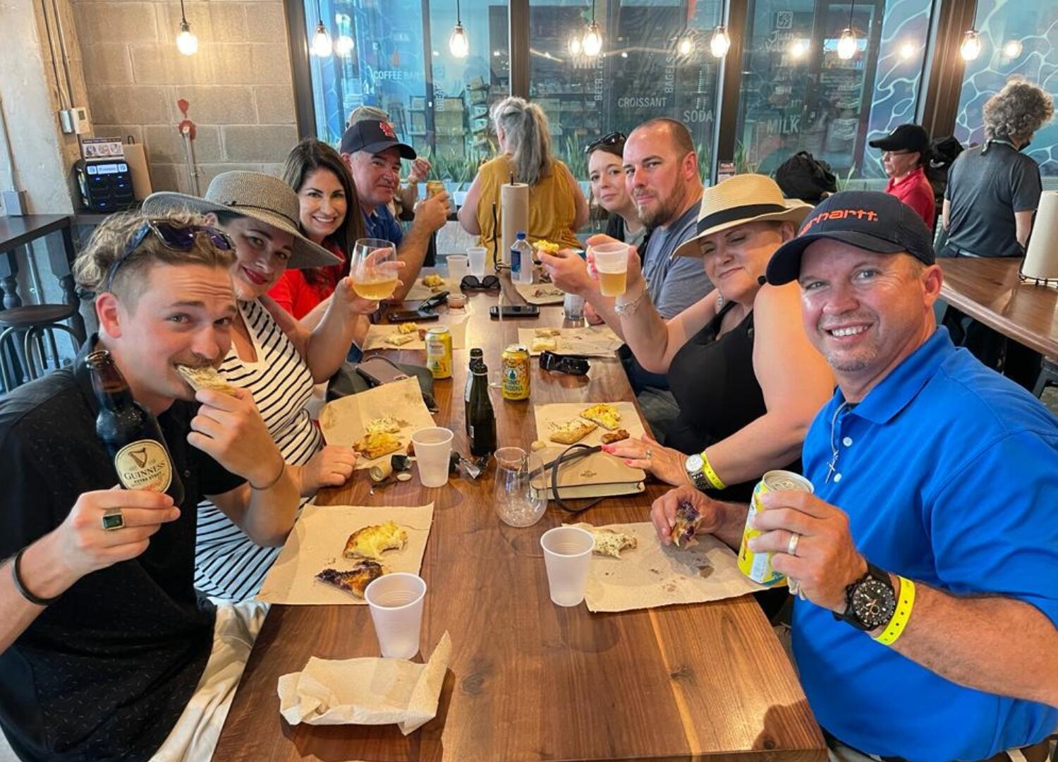 A group of people on a Miami Food Tour, sitting at a table and enjoying a culinary experience together.