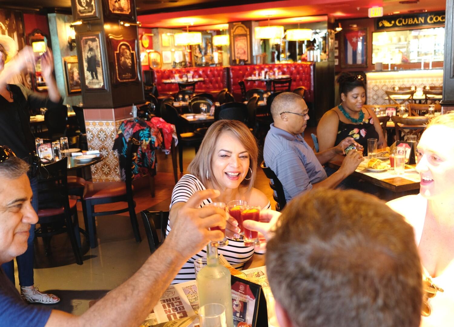 A group of people on a culinary tour at a restaurant.