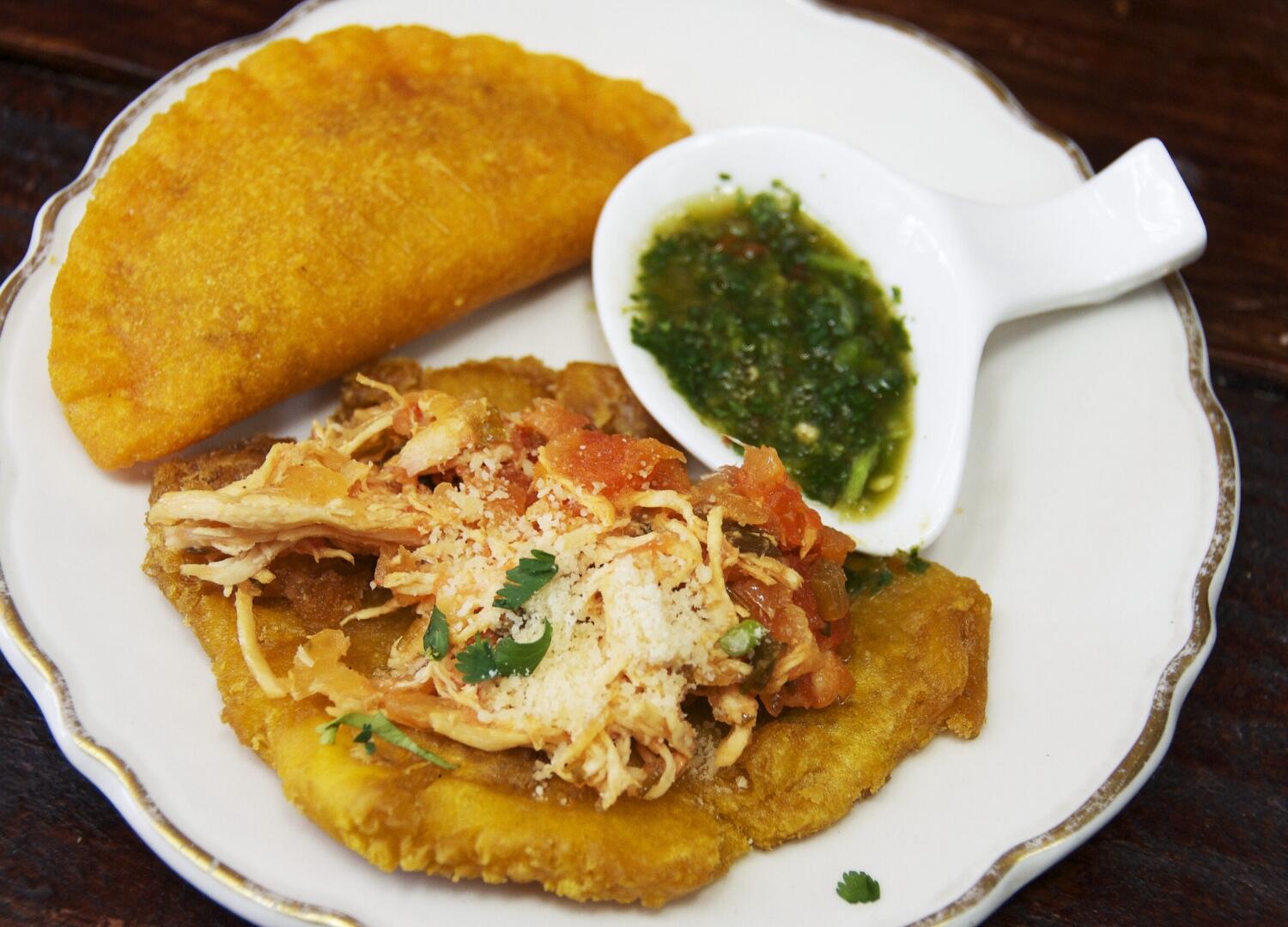 A plate with chicken and a side of guacamole on a Miami Food Tour.