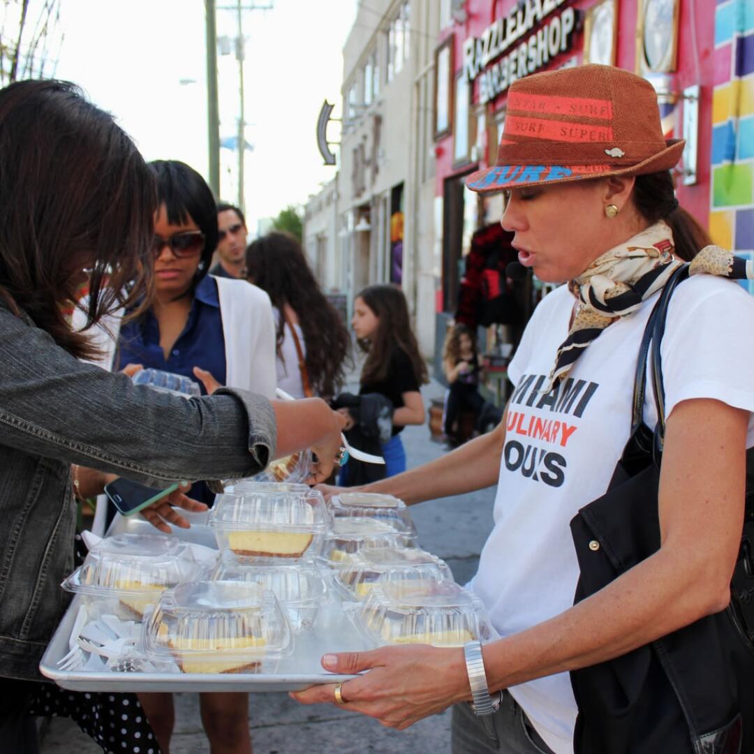 A woman holding a tray of cupcakes during a Private Tour.