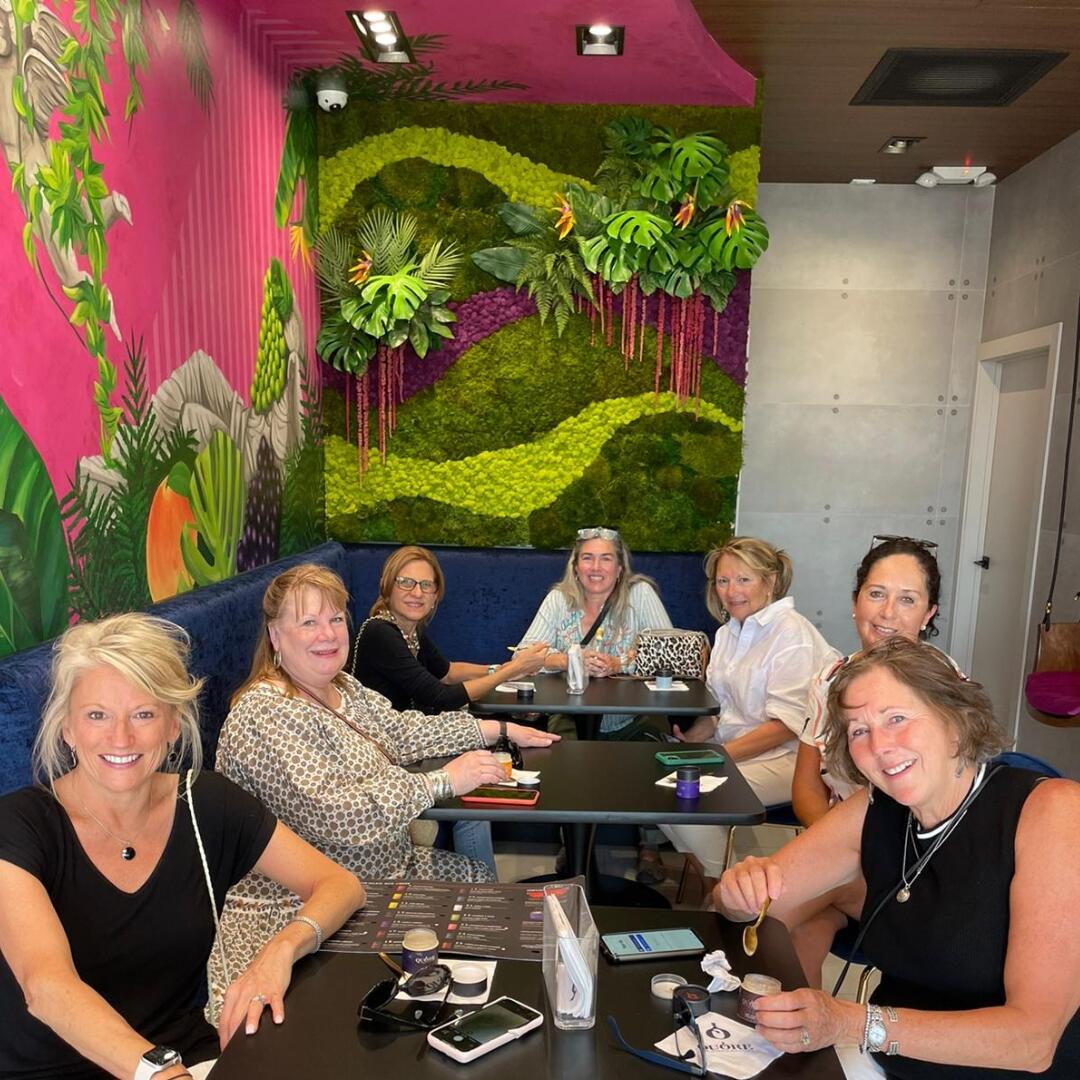 A group of women on a culinary tour, sitting at a table in a restaurant.