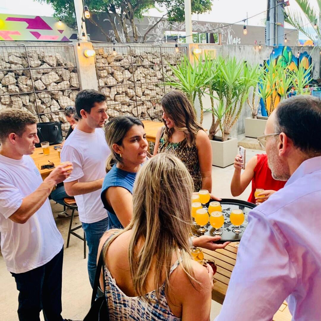 A group of people participating in a Miami Food Tour standing around a table with drinks.