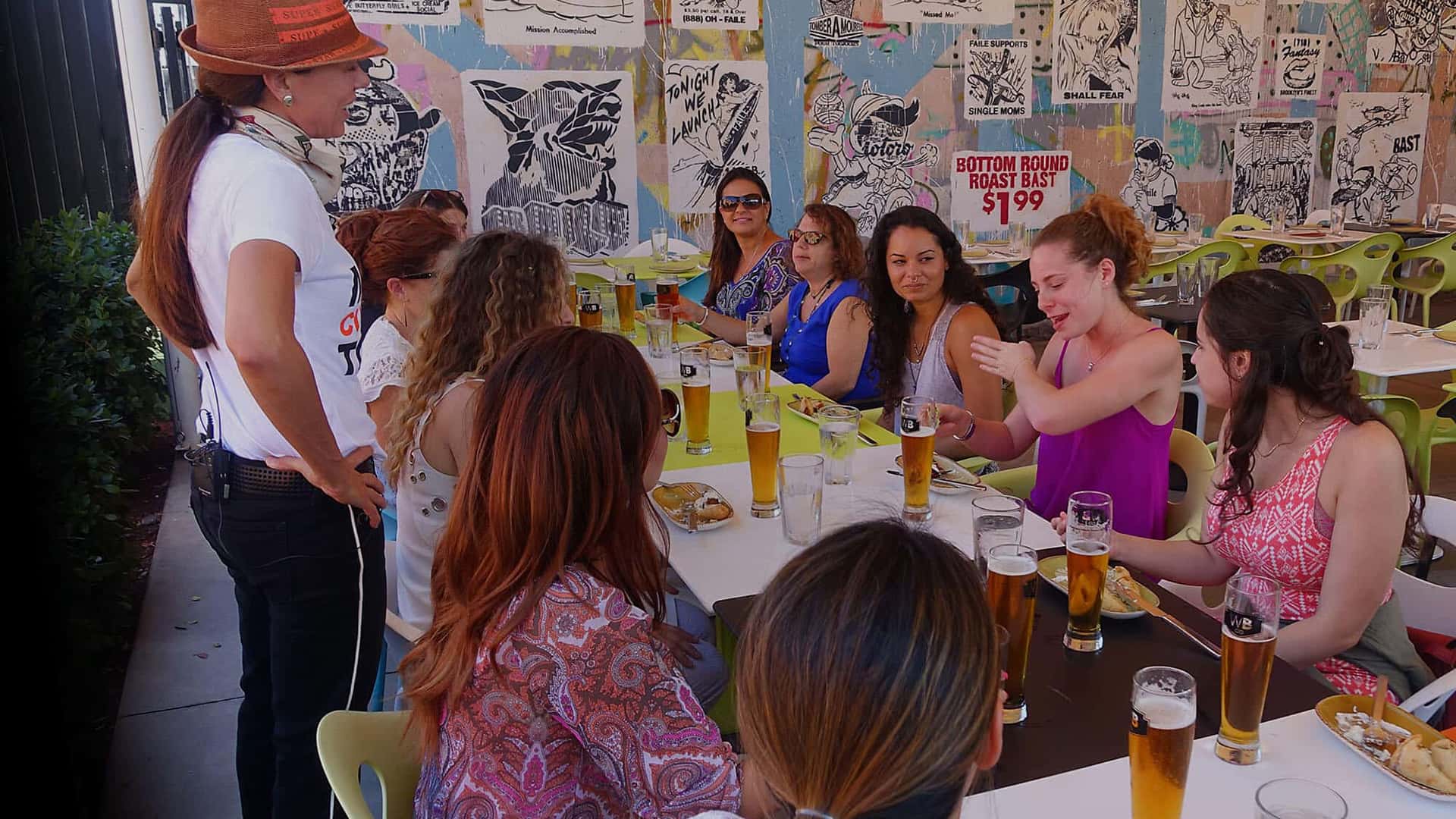 A group of people sitting at a table during a culinary tour.