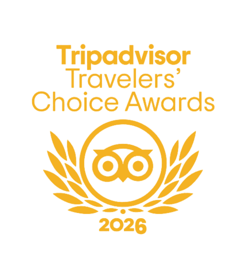 Tripadvisor Travelers’ Choice Awards 2026 logo featuring a stylized owl inside a laurel wreath, all in gold on a light background.